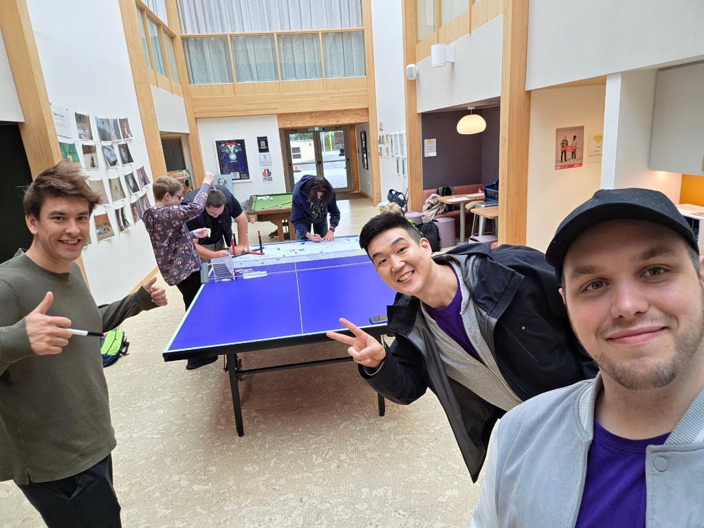 Creators collaborating around a ping-pong table at Youth Hub.